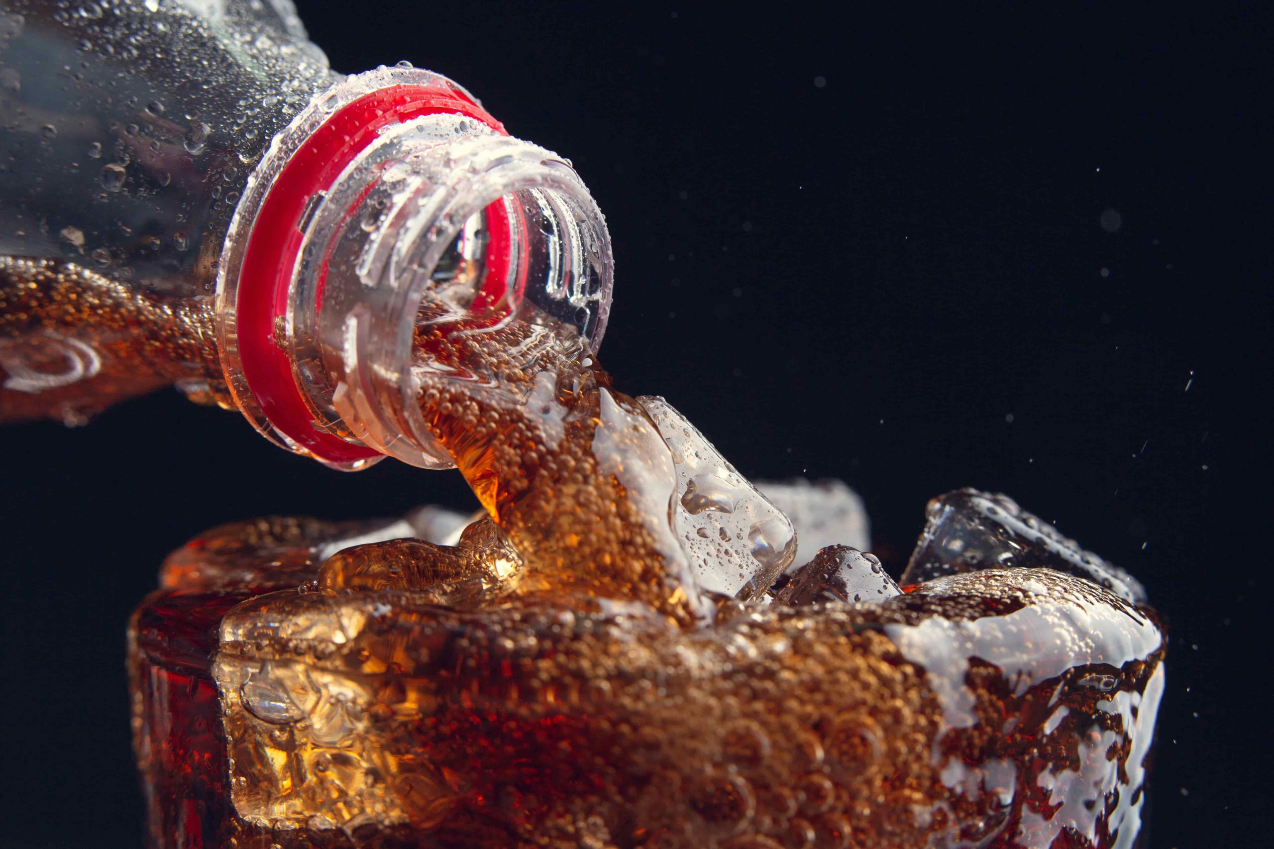 serving cola from bottle glass full ice min scaled 2